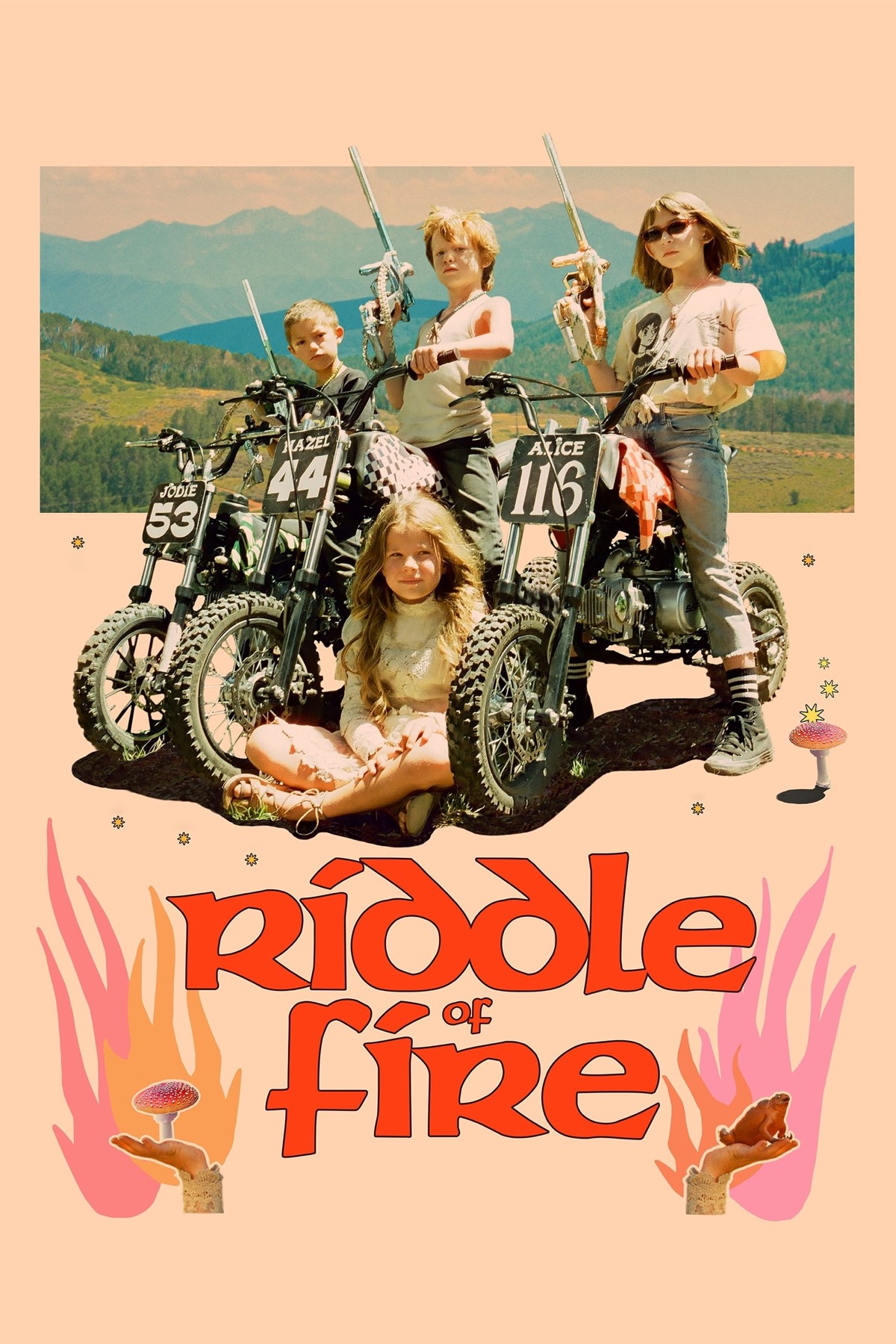 3 kids pose for the camera, straddling dirt bikes and holding paint guns. A small girl sits in front of them by their front wheels.