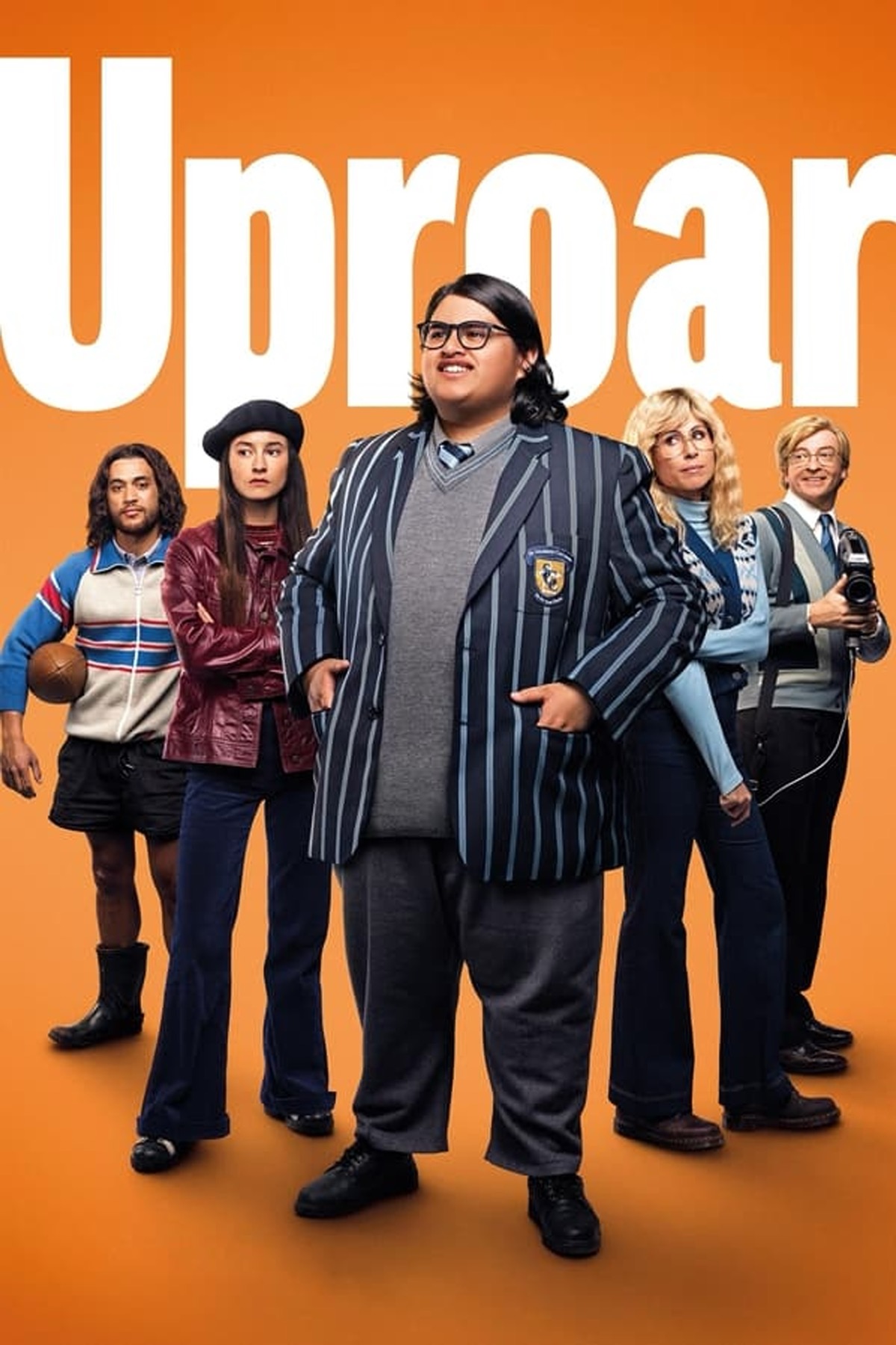 a mixed cast of characters looking out of the poster, dressed in eighties fashion, with Julian Dennison to the fore, wearing a school blazer