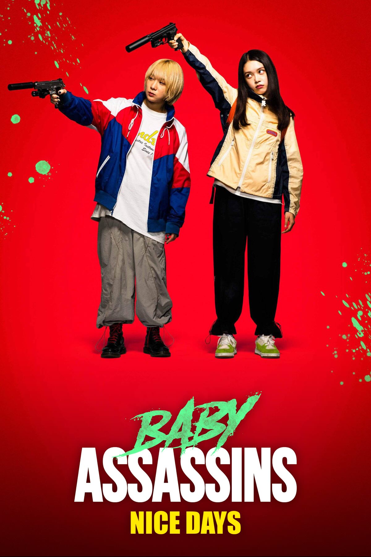 'avin it large Two young Japanese women, one blonde, the other brunette, lazily pointing guns. They're dressed so casually in tracksuits they look like they're Oasis fans.