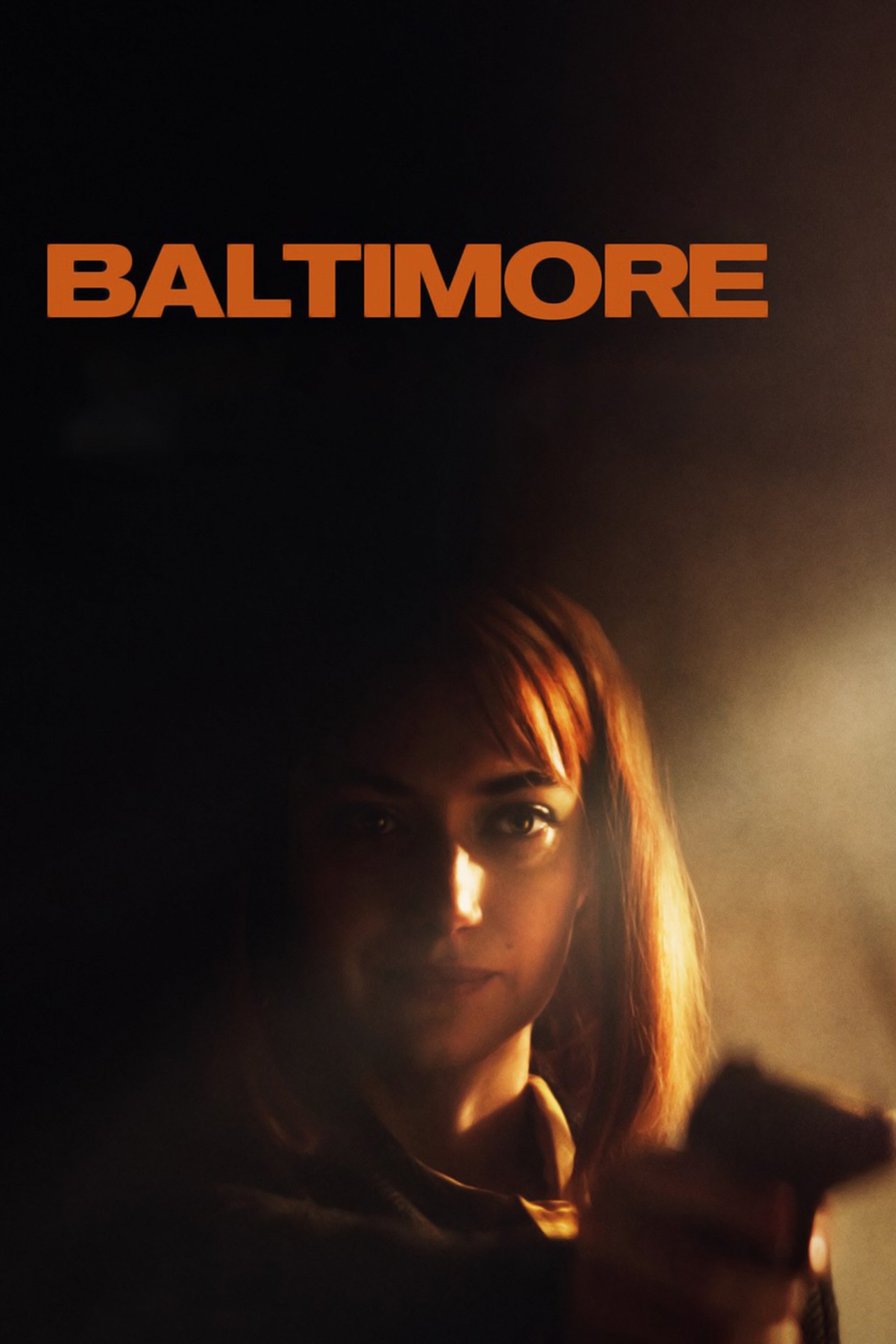 A woman with red hair, shrouded in darkness, points a gun towards the camera.