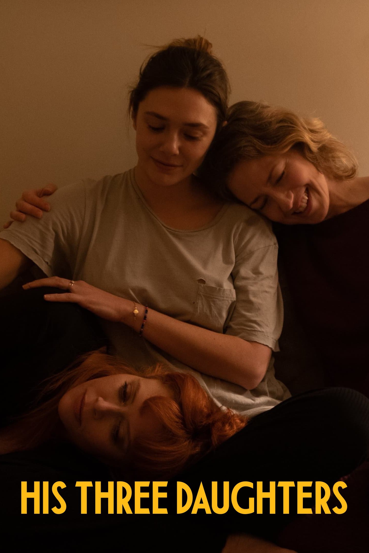 Carrie Coon, Natasha Lyon and Elizabeth Olsen sitting on a couch, hugging and comforting each other
