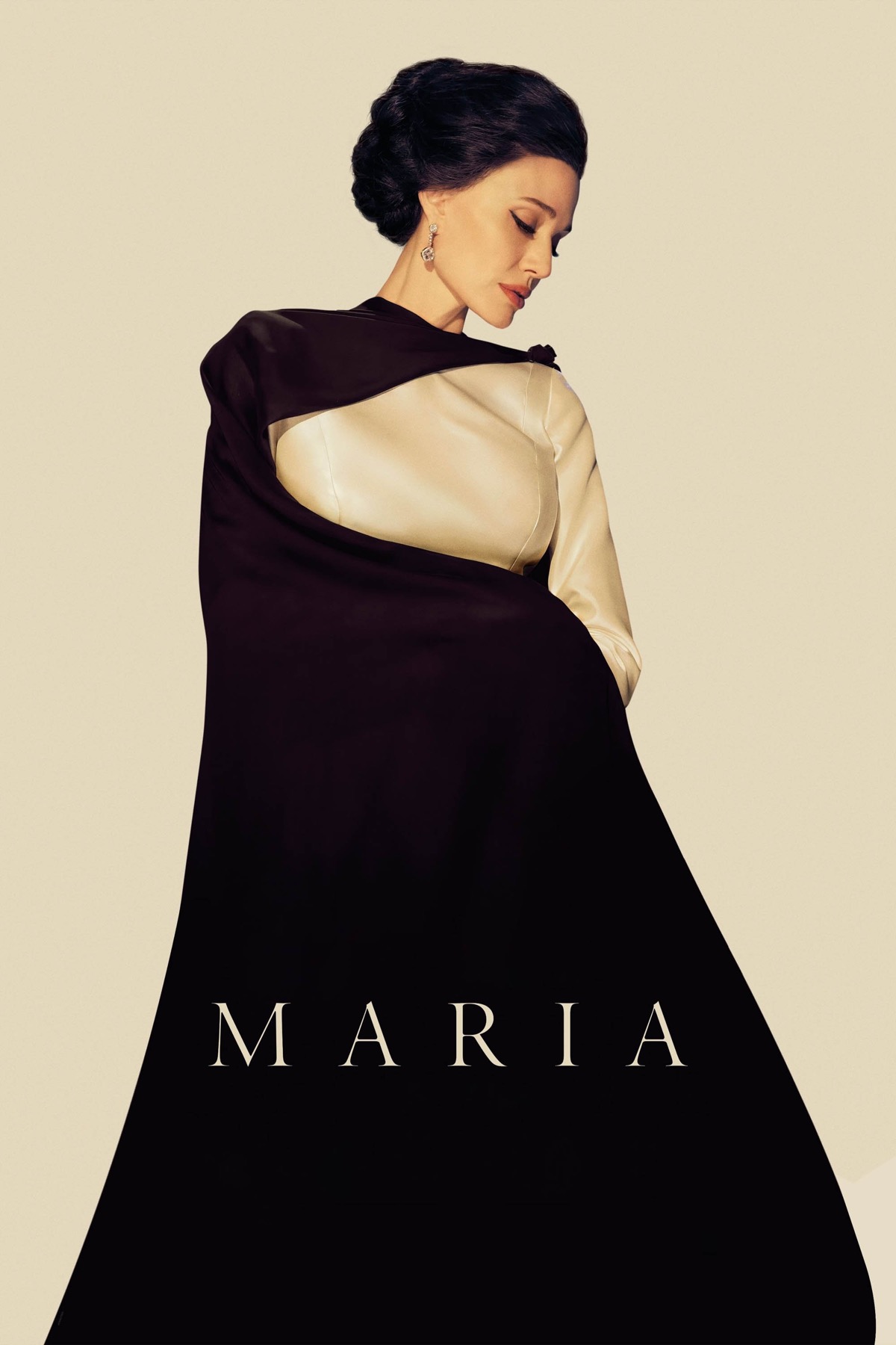 A full length photo of Angelina Jolie, dressed in an elegant black and cream gown
