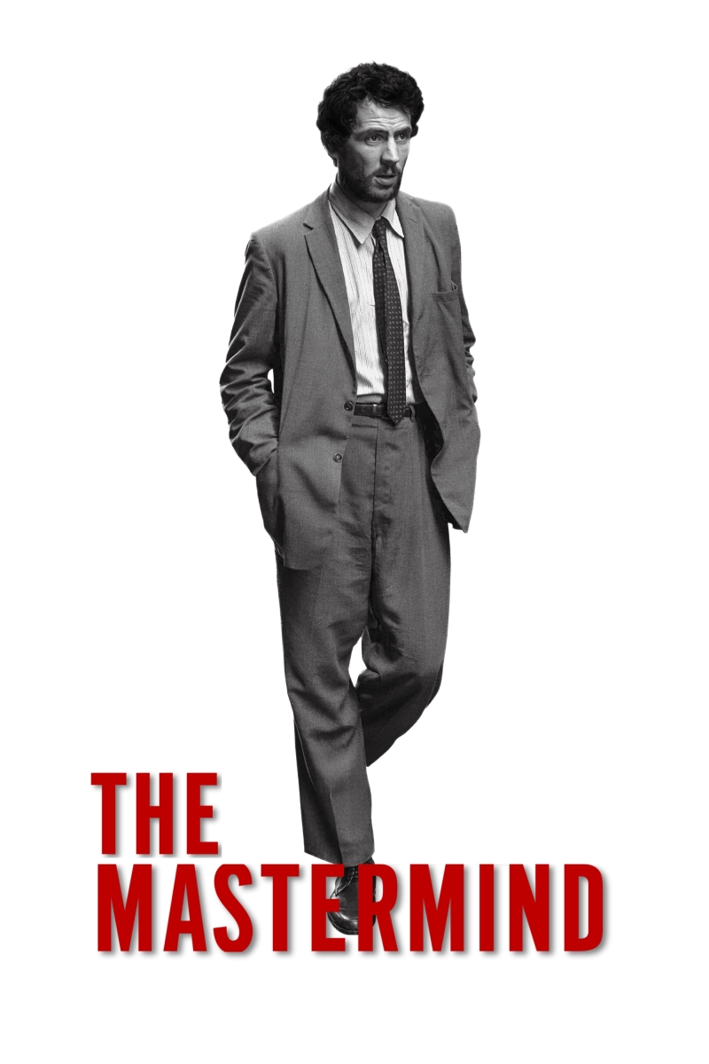 A white background with a black and white photo of a slim, middle-aged, white man, with scruffy hair and beard, wearing an ill fitting suit.