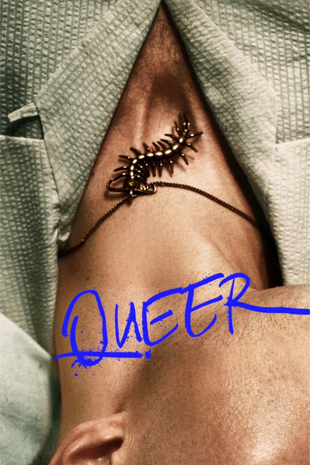 A close up of a man's neck, showing a centipede like pendant.