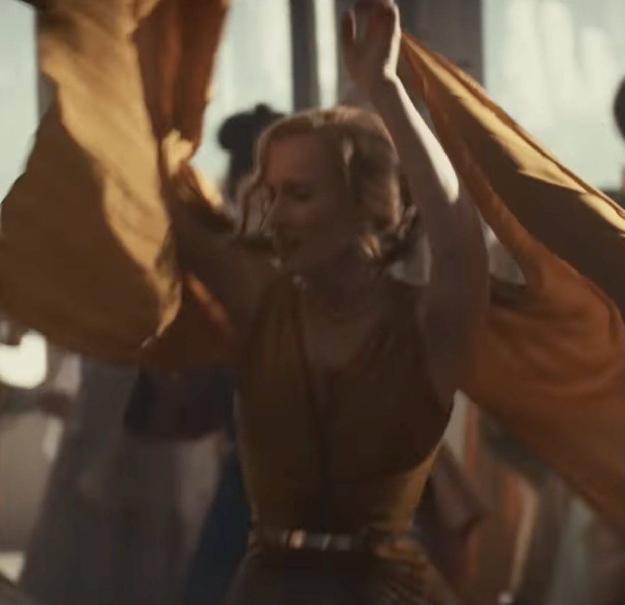 Blonde woman dancing frenetically at a sci-fi party