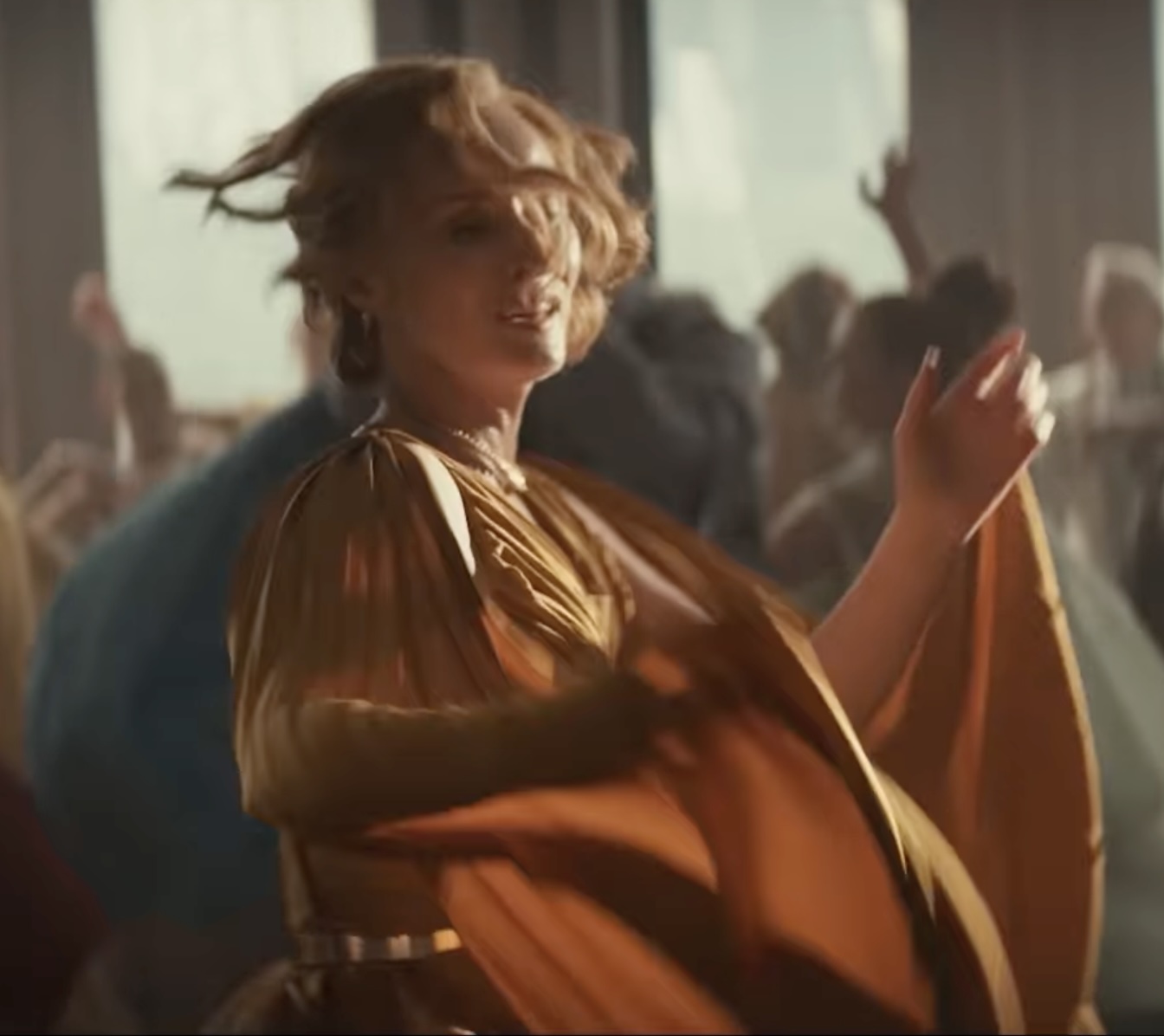 Blonde woman dancing frenetically at a sci-fi party