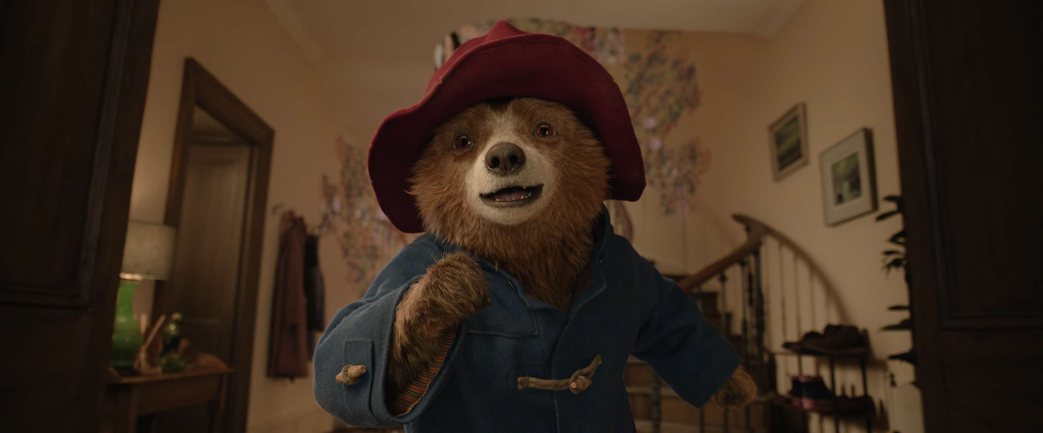 Paddington running towards the screen with a joyful grin on his face.