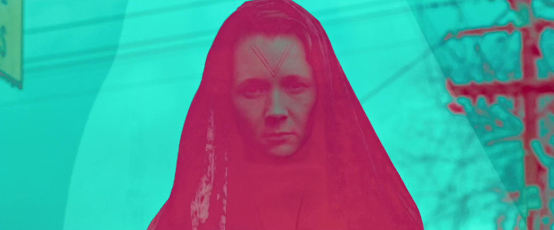 A woman in a black, hooded cloak. All the colours are psychedelic pink and green