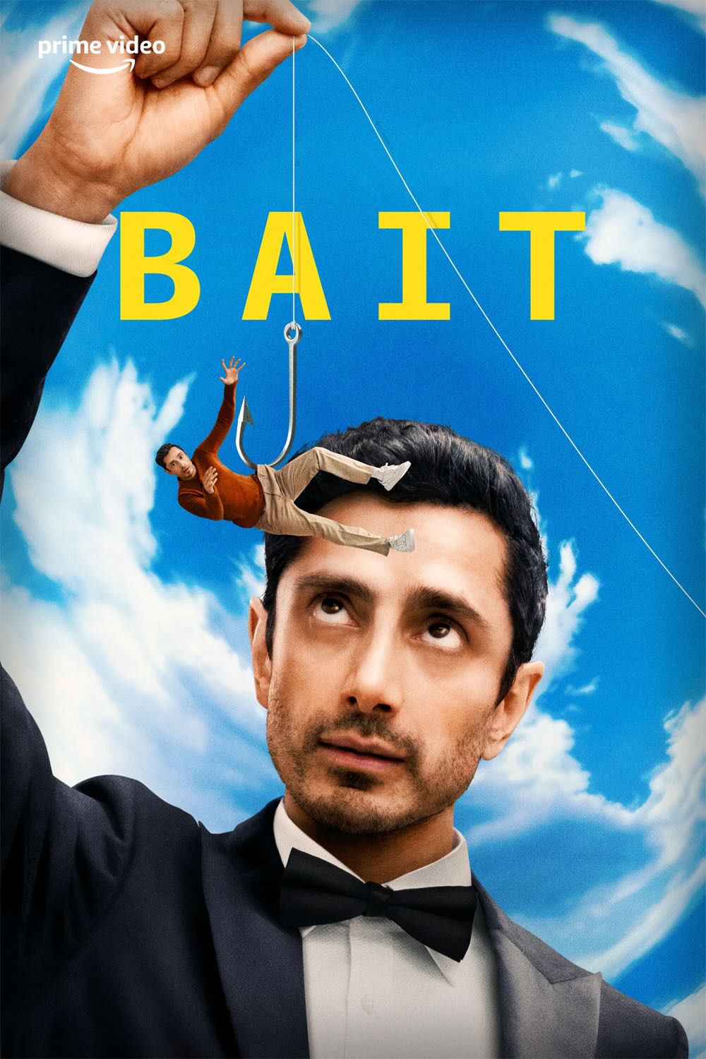 Poster for the tv series Bait. A handsome young asian man, Riz Ahmed, wearing a black and white tuxedo, works a a much smaller version of himself like a marionette puppet, suspended from strings. The puppet version is wearing casual clothes and is floundering.