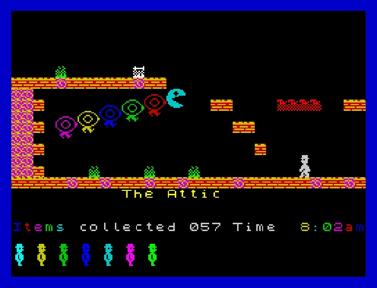 Screenshot of the game Jet Set Willy. Basically the most spectrum screenshot imaginable. Bright colours everywhere over a black background depicting a platformer environment. The level name is 'the attic'