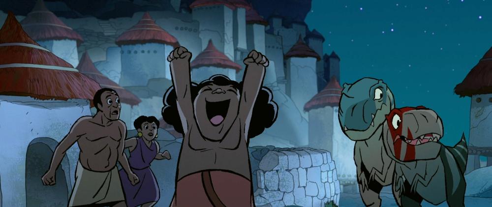 A small child with bushy black hair, wearing a tribal sarong, double-punches the air in gleeful victory. Two tribes-people and two baby T-Rex's look warily off screen.