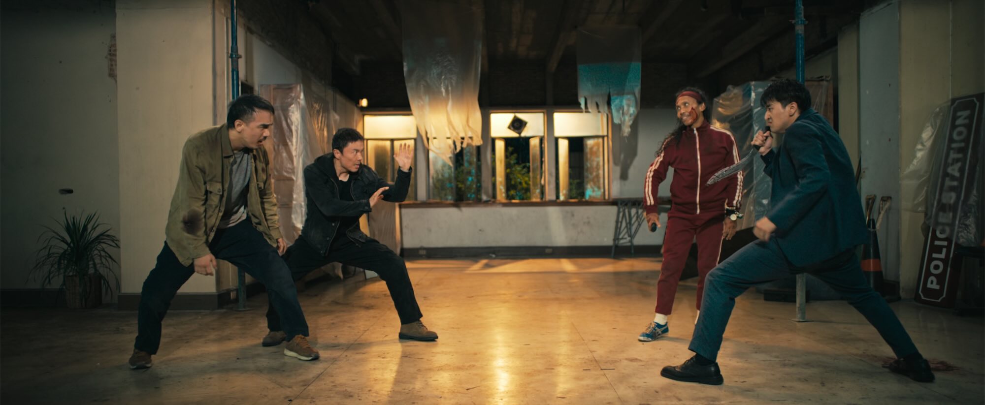 Four South East Asian men face off against each other, ready to fight, two on one side, two on the other.