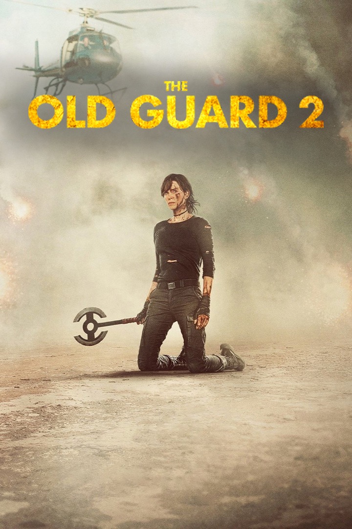 Charlize Theron kneeling in the desert, holding a battle axe