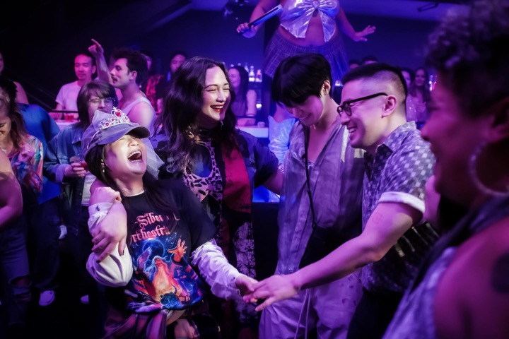 Han Gi-Chan, Lily Gladstone, Kelly Marie Tran, and Bowen Yang enjoying themselves in a nightclub
